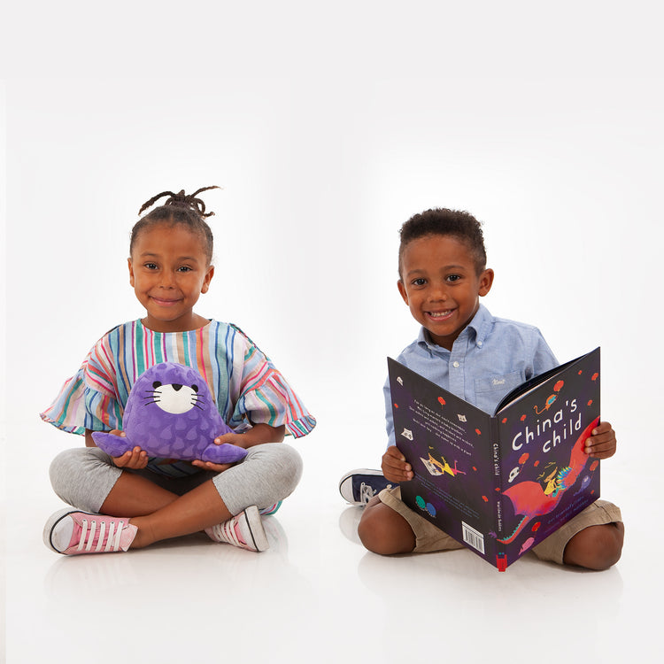 children playing with seal plush and reading story book set in china